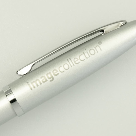 A silver metal pen with a sleek design and a clip, featuring a branding logo.