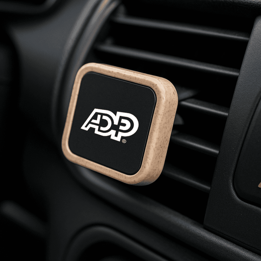 A rectangle magnetic car vent mount in black with a natural wood trim, featuring a logo on the surface.