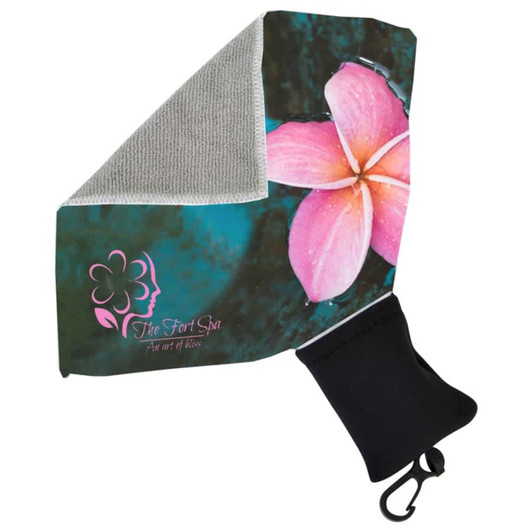 A microfibre towel with a floral design in pink and grey, stored in a black pouch featuring a logo.
