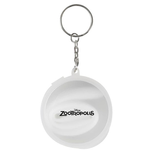A keychain featuring a round white design with a logo and branding.