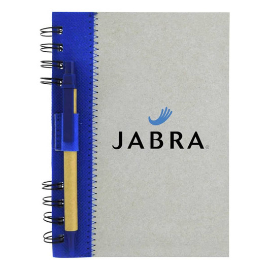 A recycled journal book with a grey cover, blue spiral binding, and a pen attached. It features a logo on the front.