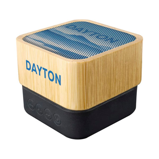 A bamboo wireless speaker in a square shape with a mesh top and black base, featuring a logo on the side.