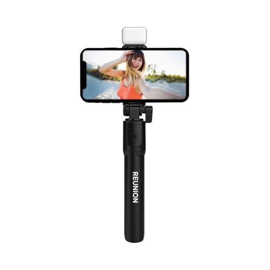 A black selfie stand with an attached phone and LED light, featuring the word "REUNION" on the handle.