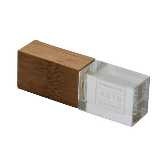An eco-friendly flash drive featuring a clear crystal body and a wooden bamboo cap.