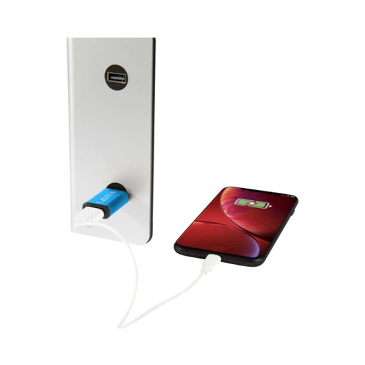 A metal USB data blocker in blue connected to a wall charger, with a phone displaying a charging indicator.