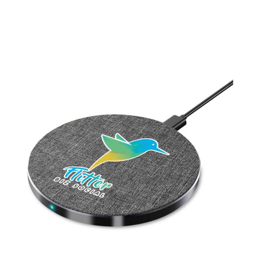 A round wireless charger in grey with a fabric texture, featuring a logo and a charging indicator light.