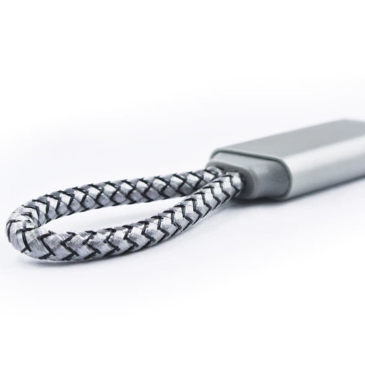 A grey and black braided charging cable with a flat connector, featuring a small logo on the body.