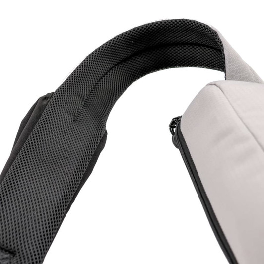 A grey eco bag with a black padded strap, featuring a textured interior. It includes a logo on the exterior.