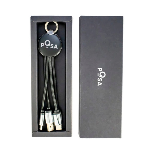A sleek black gift box containing a multi-cable keychain with USB connectors. The box has a logo.