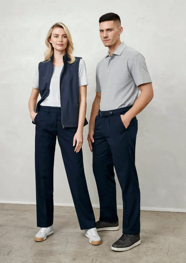 A man and woman stand together. The man wears grey polo and navy slacks; the woman wears a white t-shirt, navy vest, and navy trousers.
