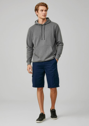A man wearing a grey hoodie and navy dress shorts, standing in a relaxed pose against a neutral background.