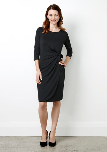 A black women's dress featuring a twist detail at the waist and three-quarter sleeves, paired with black heels.