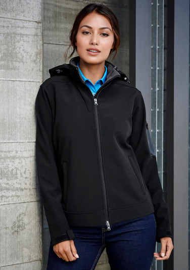 A black women's soft shell jacket with a hood, featuring a zip front and a branded logo.