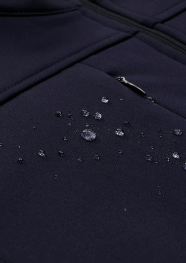 A navy men's softshell jacket with droplets of water on the fabric, showcasing its water-resistant properties.