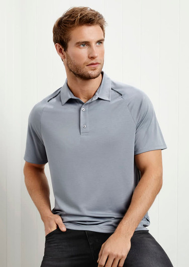 A grey short sleeve polo shirt featuring a collar and buttons, displayed on a model against a light background.