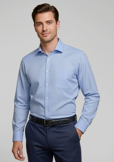 A light blue button-up shirt with long sleeves, featuring a single chest pocket and a collar, worn by a model.