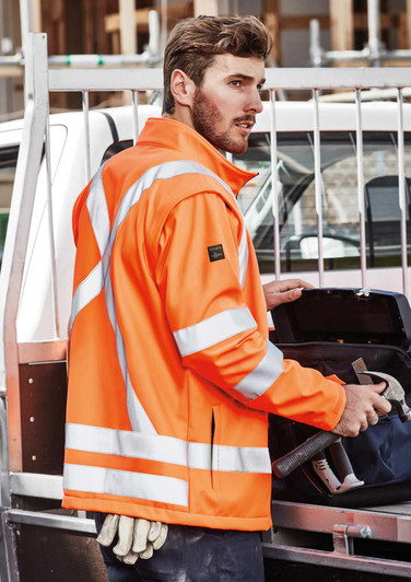 A bright orange unisex hi-vis softshell jacket with reflective stripes, displayed on a male model.