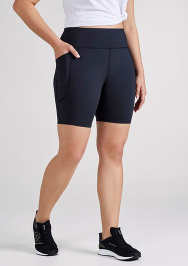 A pair of women's navy bike shorts with side pockets and a high waistband, displayed on a model.