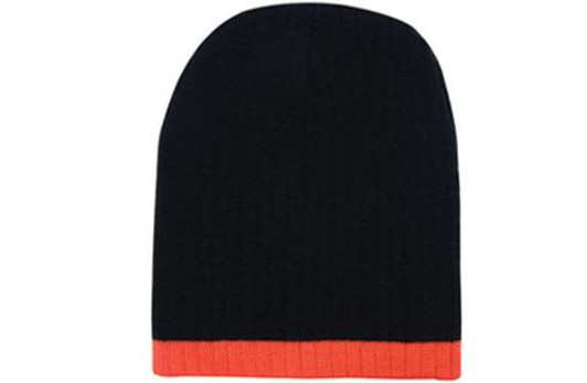 A two-tone cable knit beanie in black with an orange ribbed band at the bottom, featuring a logo.