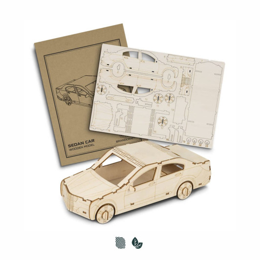 A wooden model of a sedan car, unassembled parts, and instructions in a neutral colour scheme.