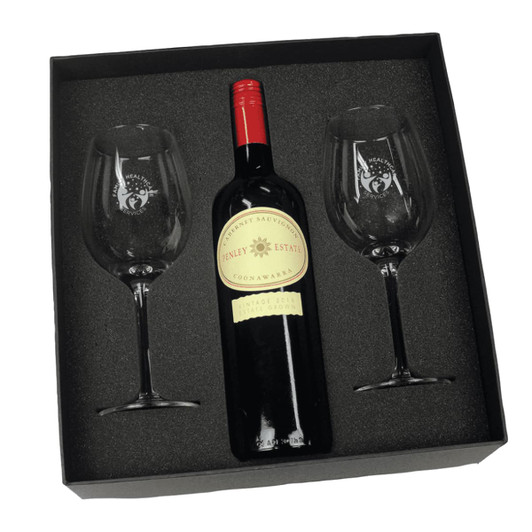 A wine gift box featuring a red wine bottle and two crystal wine glasses, all set in a black foam insert.