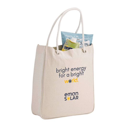 A cream-coloured tote bag with rope handles, featuring a branding logo and a pouch of snacks inside.