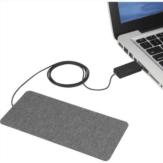 A grey ultra-thin fabric wireless charging pad connected to a laptop with a black cable.