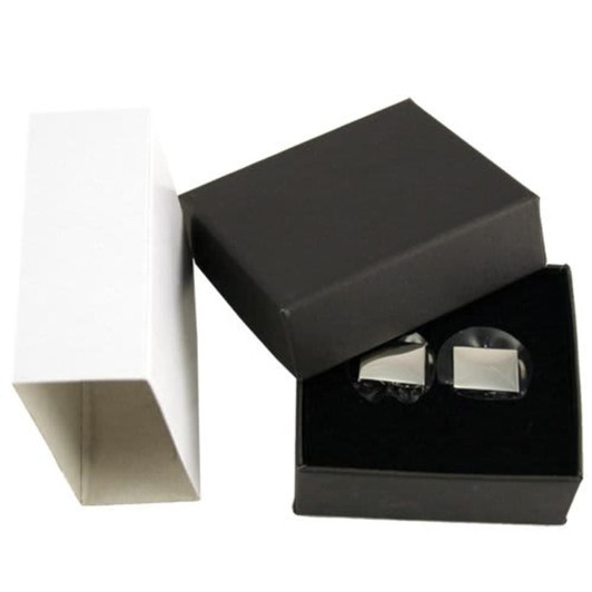 A pair of plain silver cufflinks displayed in a black box, with a white box beside it.