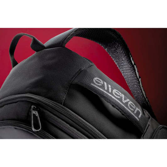A black backpack featuring a textured strap and a logo. It has multiple compartments and zippers.