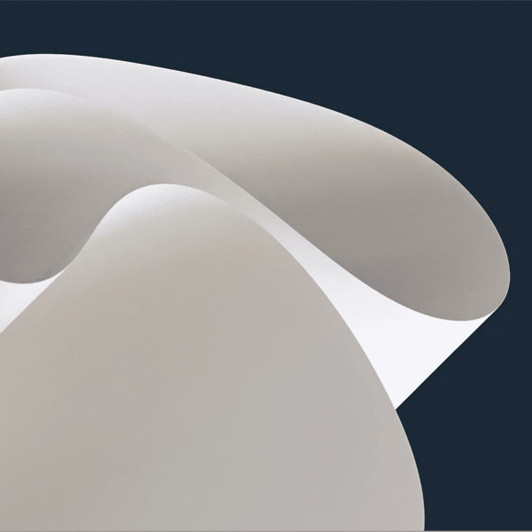 A soft, curved surface in shades of grey, resembling a flexible material against a dark background.