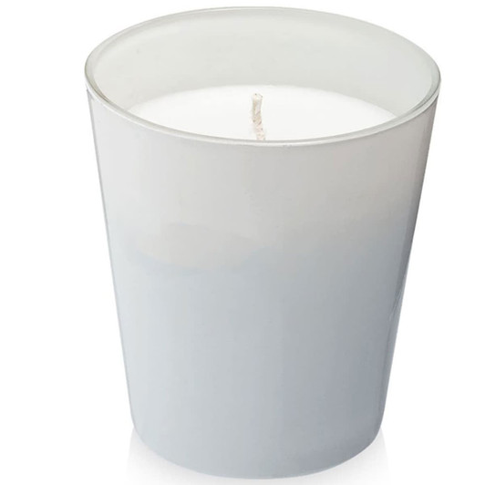 A grey glass candle holder with a white wax candle inside, featuring a single wick at the centre.
