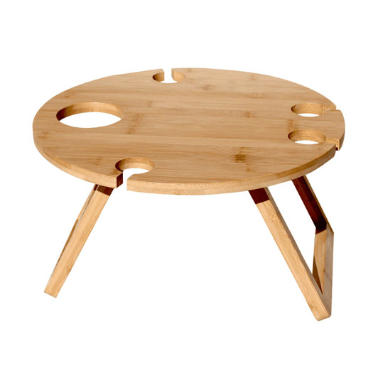 A round bamboo picnic table with cut-out sections for drinks, featuring wooden legs. It has a natural finish.
