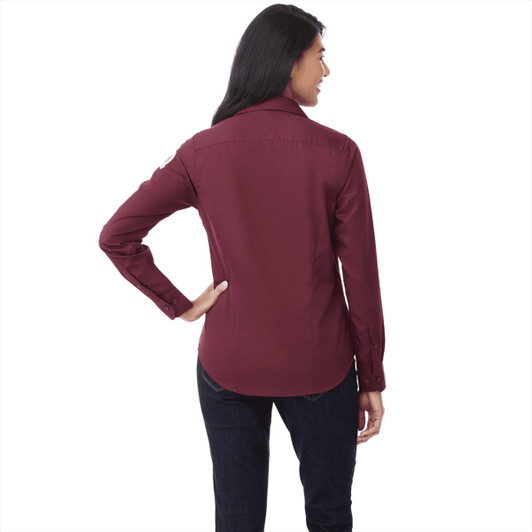 A burgundy women's button-up shirt with long sleeves and a back view, featuring a logo on the collar.