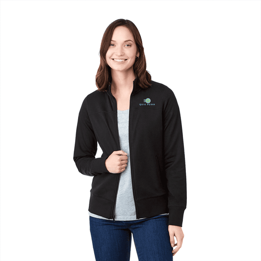 A woman wearing a black Argus Eco Fleece Full Zip jacket, featuring a logo on the chest.