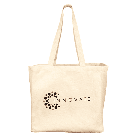 A cream-coloured reusable grocery tote bag with a logo on the front and two large handles.