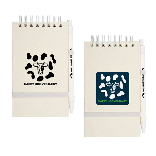 A notepad with a cow pattern cover, featuring a white pen attached, in light and dark colors.