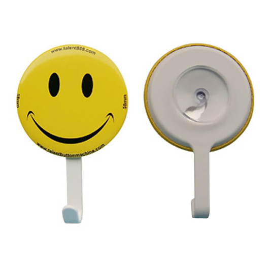 A yellow smiley face button badge with a white hanger, featuring a logo on one side.
