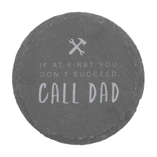 A round slate coaster featuring grey tones and an inscription about calling Dad for help.