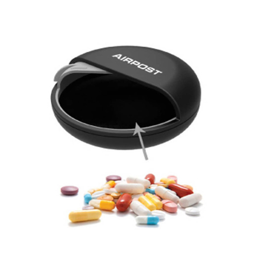 A black pill box with a curved opening, surrounded by various colourful pills and capsules.