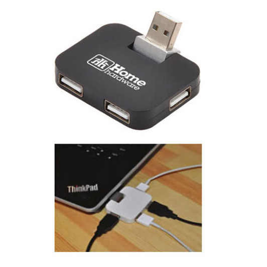 A black USB hub featuring multiple ports, with a logo, positioned near a laptop and connected cables.