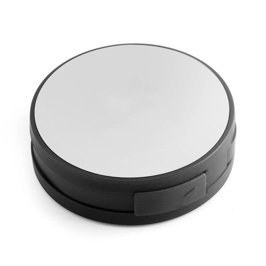 A circular USB hub in black with a reflective surface. It features one side with ports for connectivity.