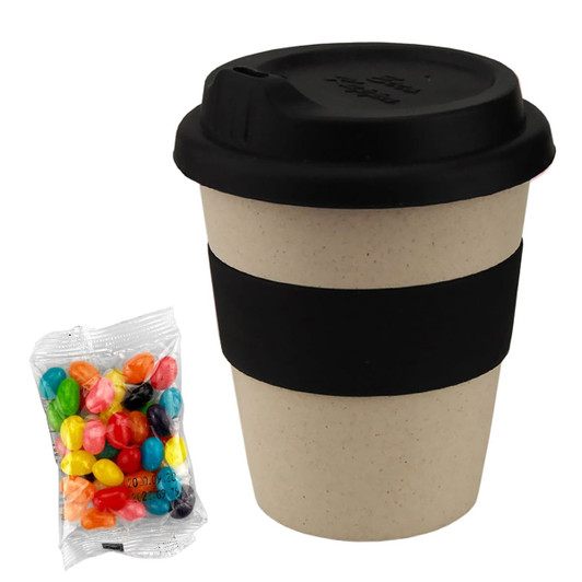 A bamboo cup with a black silicone lid and band, alongside a clear bag of colourful jelly beans.