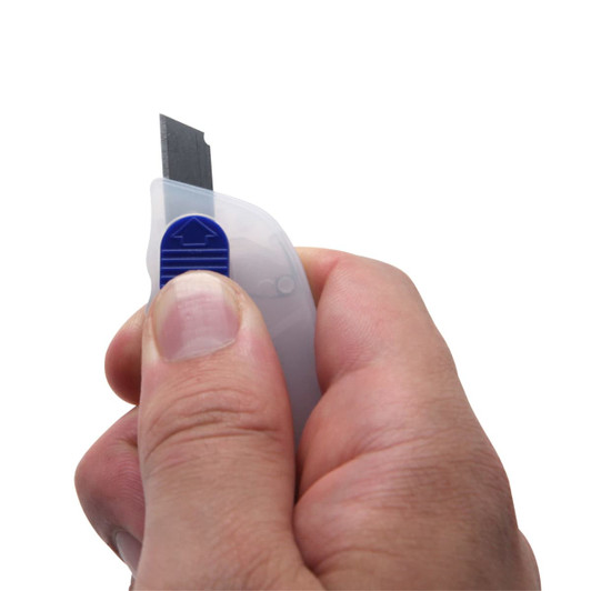 A mini cutter key ring held in a hand, featuring a grey body with a blue detailing and a retractable blade.