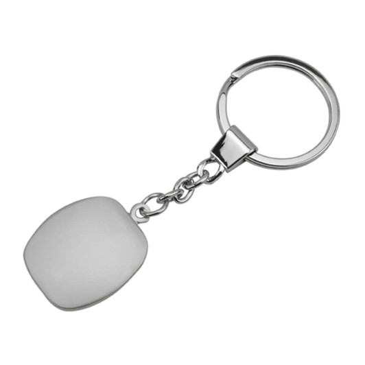A metallic key ring with a smooth, white cubic pendant attached by a chain.