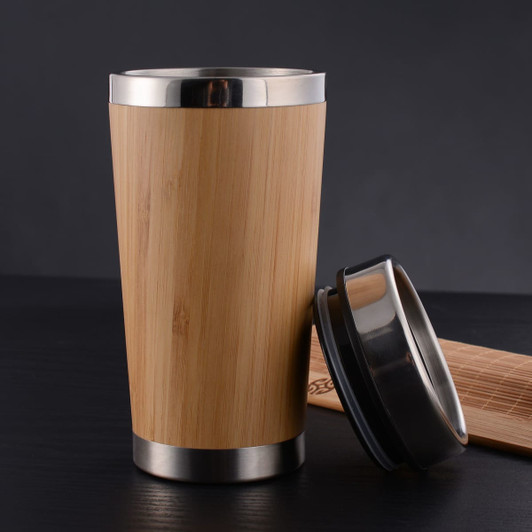 A bamboo reusable coffee mug with a stainless steel base and lid, showcasing a natural wood finish.