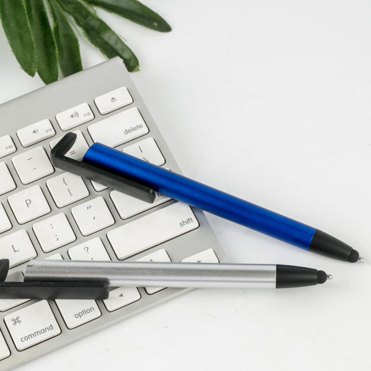 A blue and a silver plastic pen rest beside a computer keyboard on a white surface.