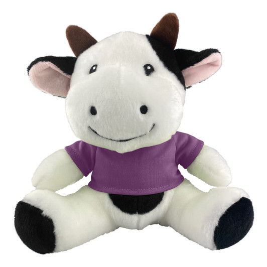 A plush cow toy featuring black and white fur with brown horns, wearing a purple shirt. It has a friendly smile and soft texture.