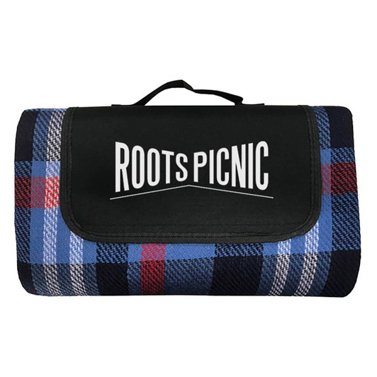 A folded blue and black tartan picnic blanket with a black carrying handle and a logo on the front.