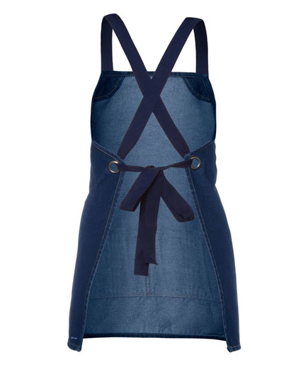 A navy denim bib apron with a cross-back design and ties at the waist, featuring a branding logo.