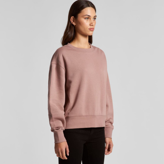 A pink jumper with long sleeves and a round neckline, displayed on a model against a neutral background.
